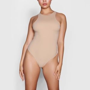SKIMS high neck bodysuit in color clay. Never before worn.